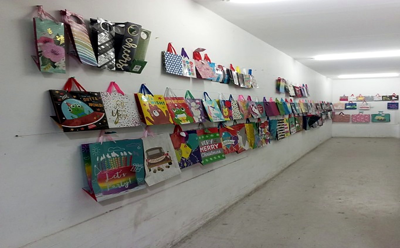 Gift bag showroom wall with hundreds of PT Glory Offset Press designs on display